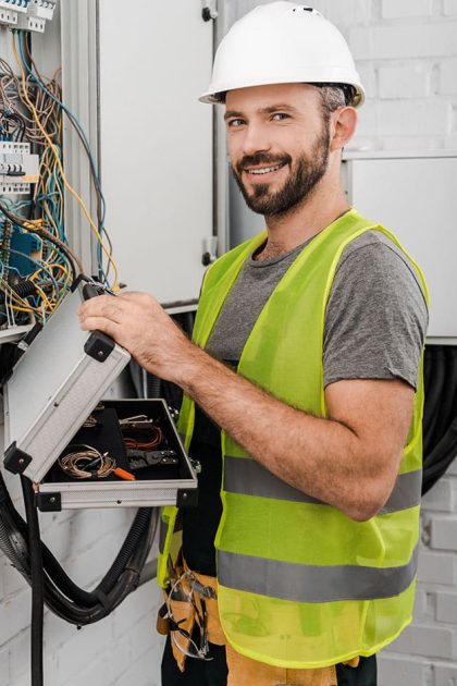 smiling-handsome-electrician-holding-toolbox-near-2023-11-27-04-59-32-utc